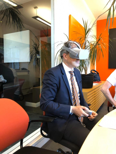 Julian trying a VR headset during a visit to Peel Entertainment